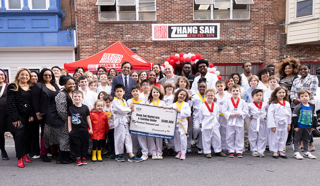 Senator Saval stands with students, faculty, and staff of Zhang Sah Martial Arts & Learning Center at an event celebrating a $500,000 state grant to the school to expand its facilities and operations.